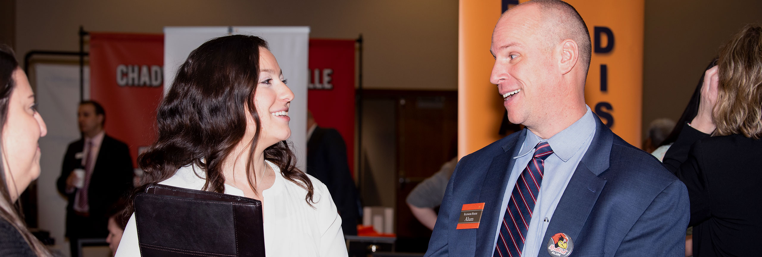 Faculty talking on a career fair event.