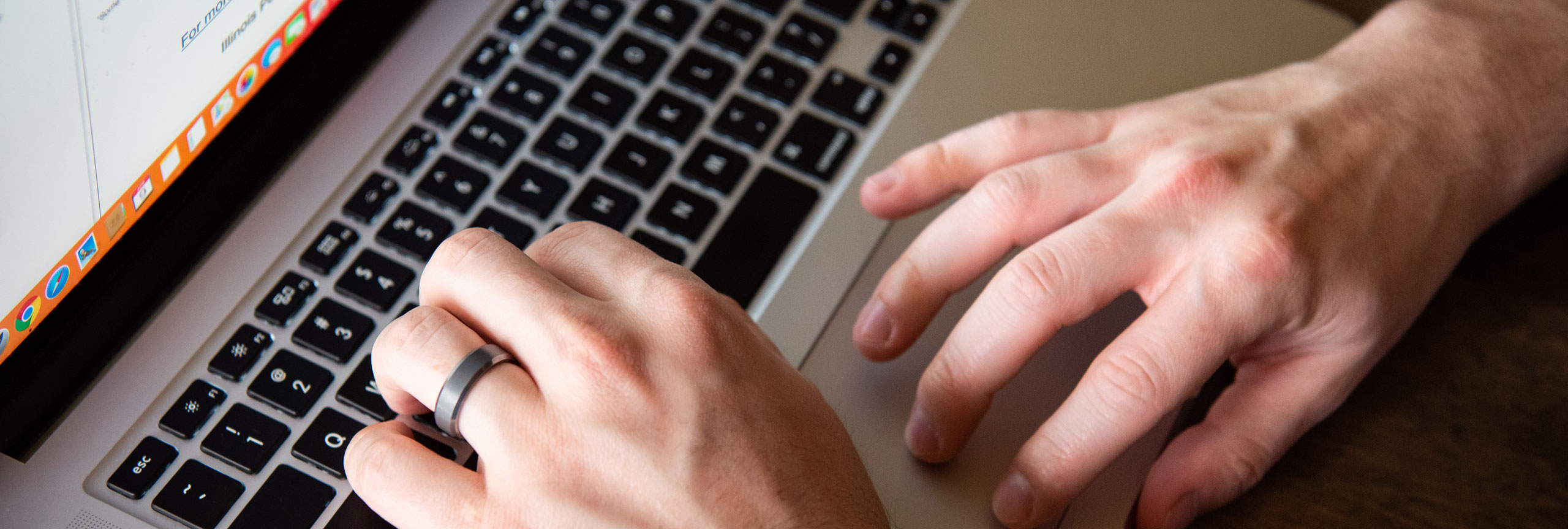 Hands on a notebook keyboard.
